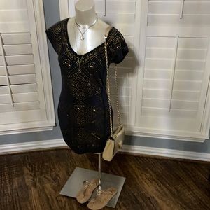V-neck dress with brass design on front